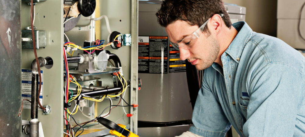 Technician performing annual furnace maintenance in Buffalo NY. We also service Clarence, NY and surrounding areas.