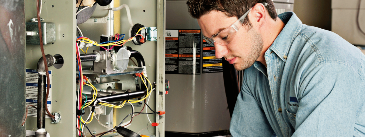 Technician performing annual furnace maintenance in Buffalo NY. We also service Clarence, NY and surrounding areas.